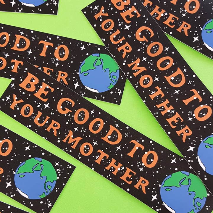 Stickers with 'Be Good to Your Mother' text and Earth graphics on a green background