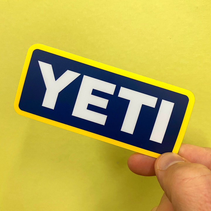 YETI logo on a blue and yellow background