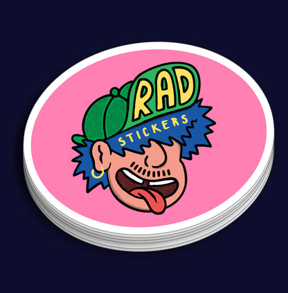 Stack of custom oval stickers with a colourful design and 'RAD STICKERS' text on a pink background
