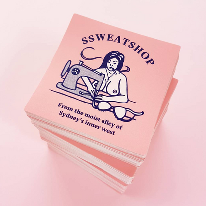Stack of pink stickers with 'SSWEATSHOP' design and text on a pink background